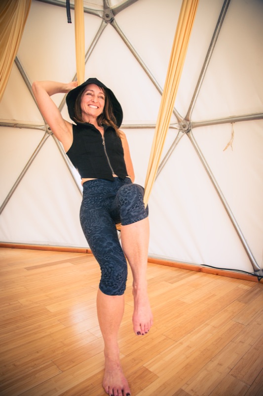 Maura Rassman in a gold swing inside the Aum Dome